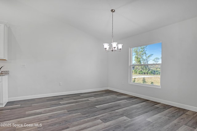 unfurnished dining area with baseboards, a chandelier, and wood finished floors