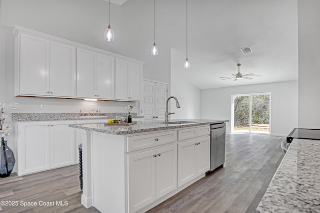 kitchen featuring dishwasher, white cabinets, a sink, and light wood finished floors