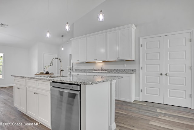 kitchen featuring a center island with sink, light wood-style flooring, white cabinetry, vaulted ceiling, and dishwasher