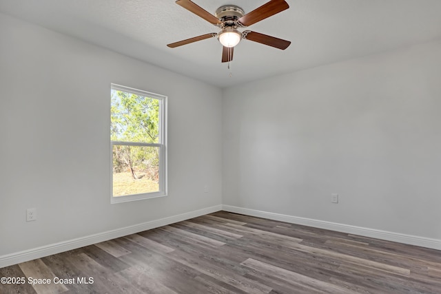 unfurnished room with a ceiling fan, baseboards, and wood finished floors