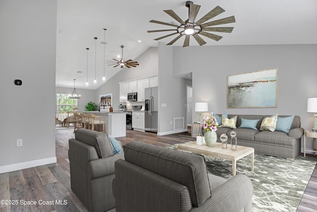 living room with baseboards, visible vents, wood finished floors, high vaulted ceiling, and ceiling fan with notable chandelier