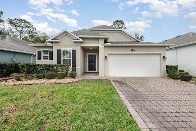 view of front facade with a front yard and a garage