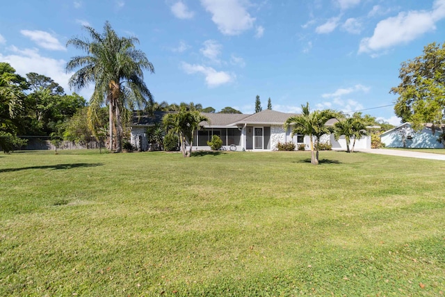 view of front of house featuring a garage and a front lawn