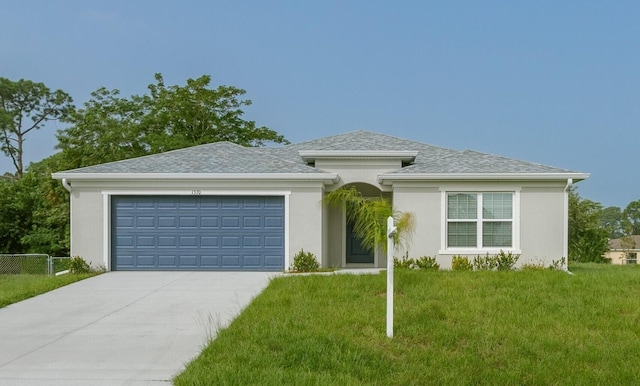 view of front facade with a garage and a front lawn