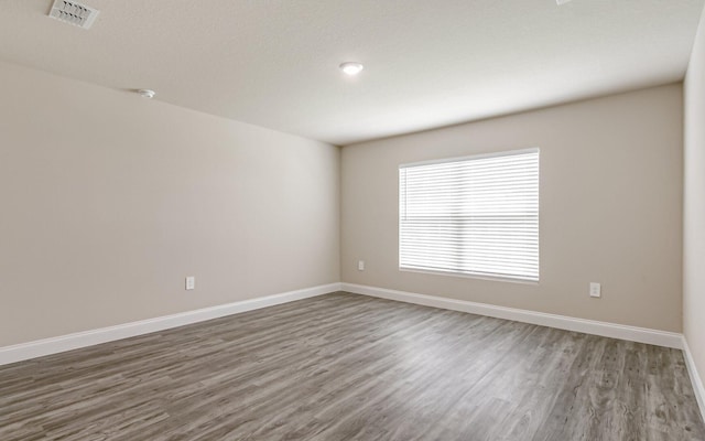 spare room featuring dark hardwood / wood-style floors