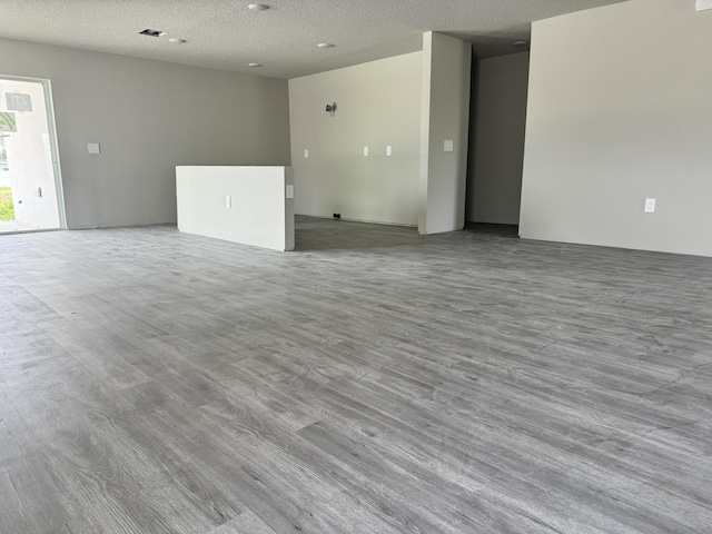 empty room featuring light hardwood / wood-style floors and a textured ceiling