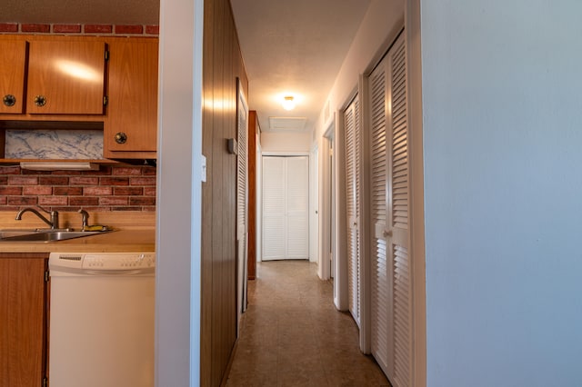 hallway with a textured ceiling and sink