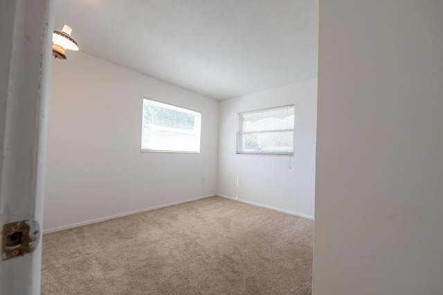 unfurnished room with light carpet