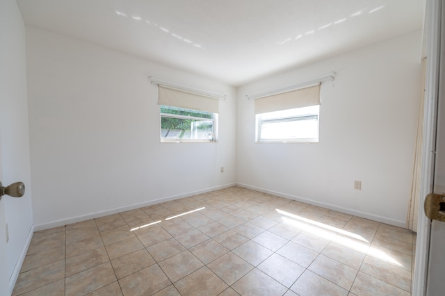 unfurnished room with light tile patterned floors