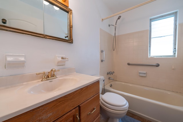 full bathroom with vanity, tiled shower / bath combo, and toilet