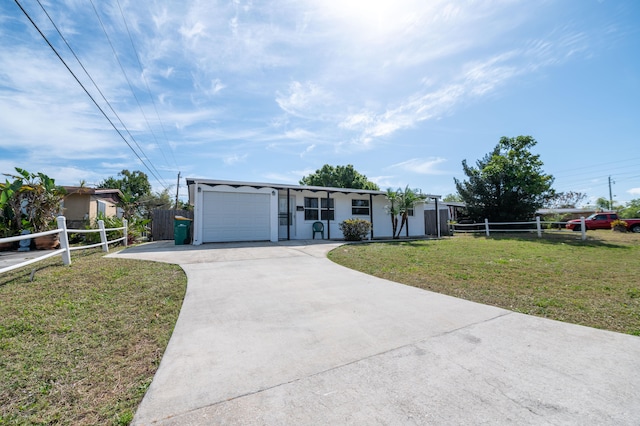 single story home featuring a garage and a front lawn