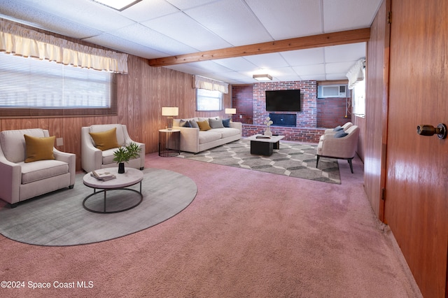 carpeted living room with wooden walls and beamed ceiling