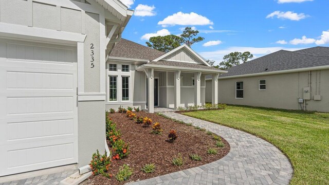 entrance to property with a lawn