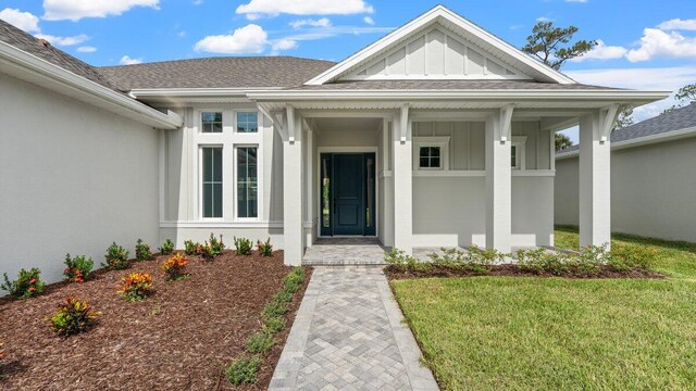 property entrance with a yard