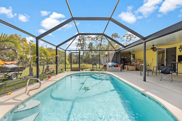 view of swimming pool featuring a patio, ceiling fan, and glass enclosure