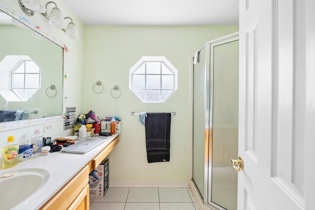 bathroom with a shower with door, tile flooring, and vanity