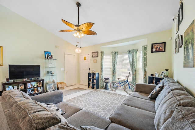 tiled living room with ceiling fan and high vaulted ceiling