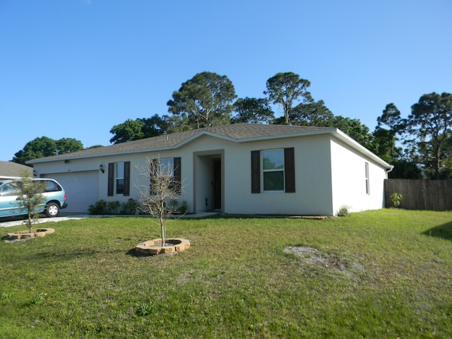 single story home featuring a front yard and a garage