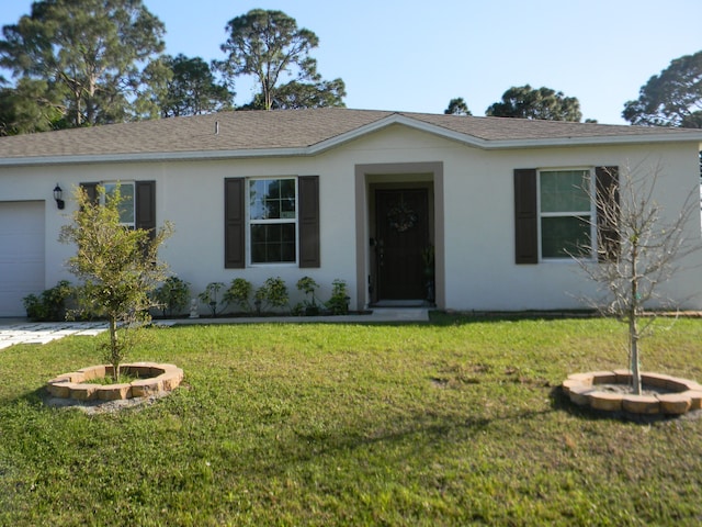 ranch-style home with a front lawn and a garage