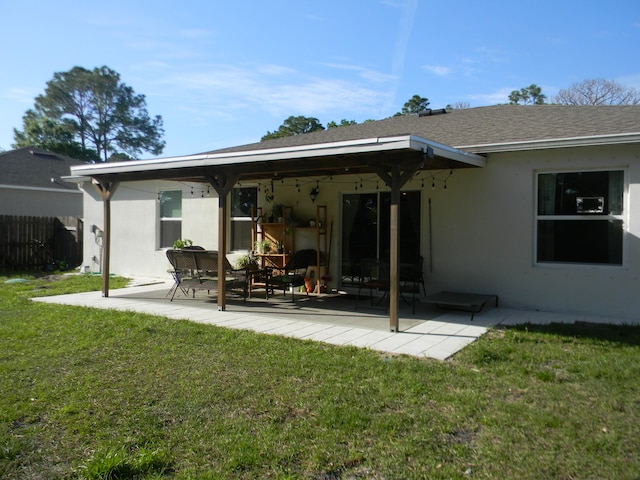 rear view of house featuring a yard and a patio area