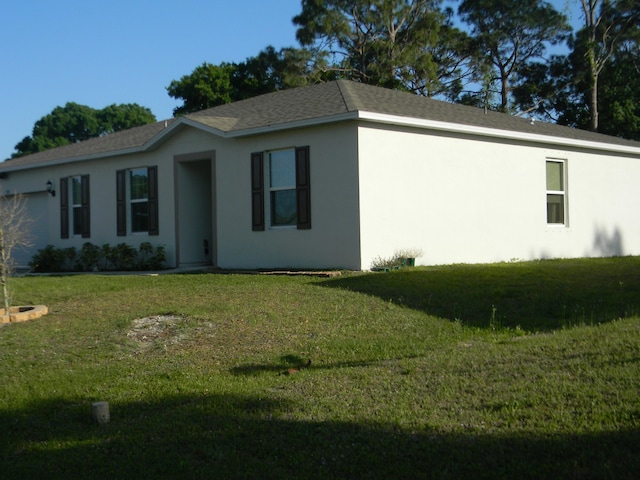 view of side of home featuring a lawn