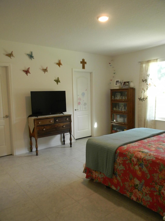 bedroom with light tile floors