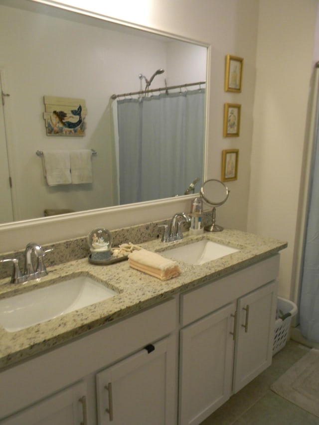 bathroom featuring dual vanity and tile flooring