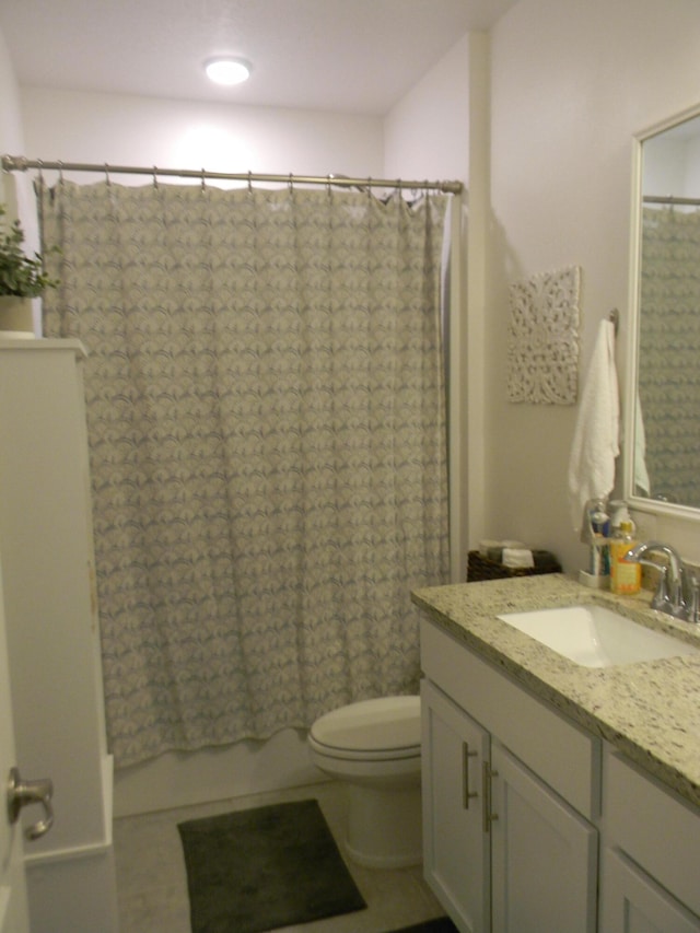 full bathroom with vanity, tile floors, shower / bath combo, and toilet