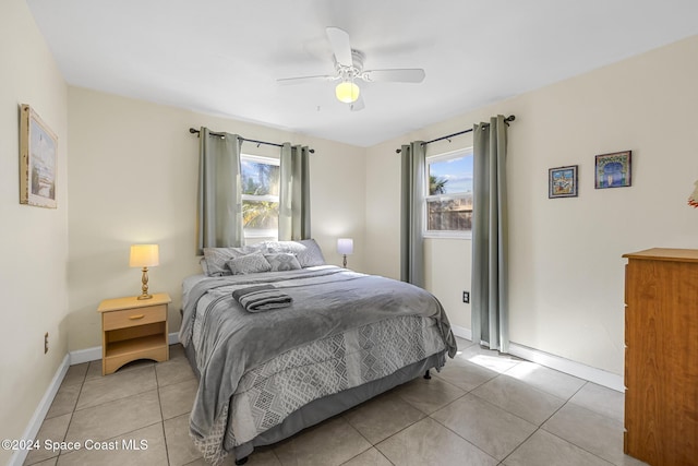 bedroom featuring light tile patterned floors and ceiling fan