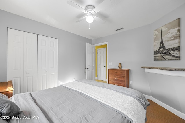 bedroom featuring hardwood / wood-style floors, a closet, and ceiling fan