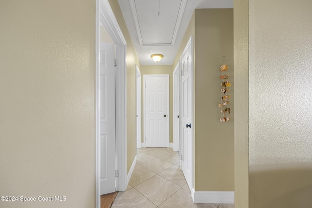 corridor featuring light tile patterned flooring