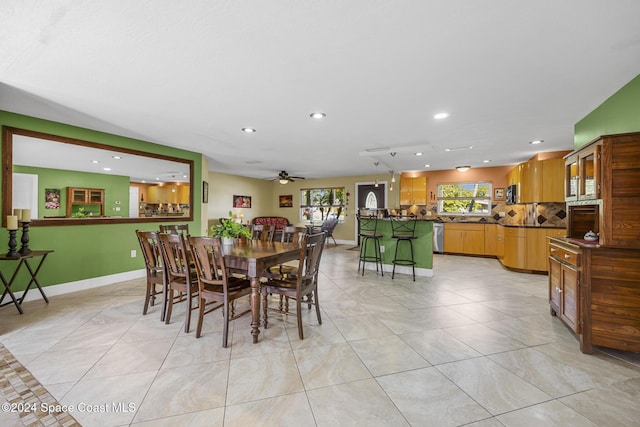 tiled dining space featuring ceiling fan