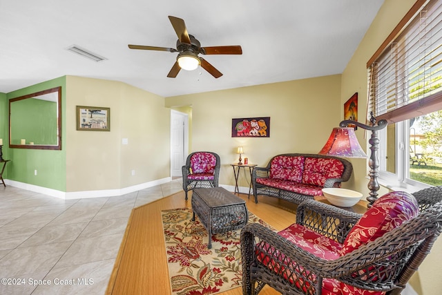 tiled living room featuring ceiling fan