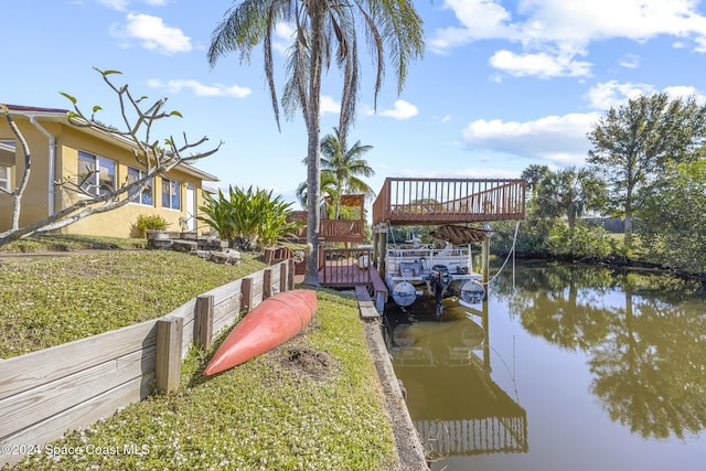 dock area featuring a lawn and a water view