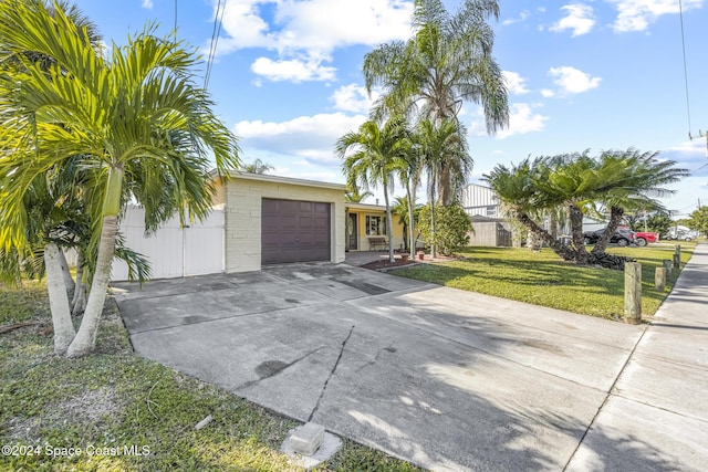 view of front of property with a front lawn and a garage