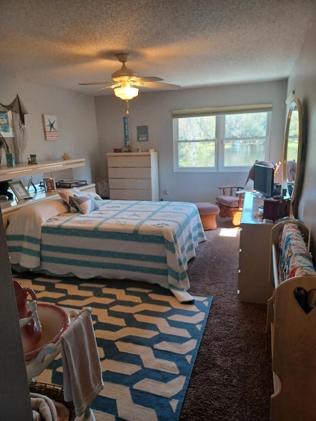 bedroom featuring carpet, a textured ceiling, and ceiling fan