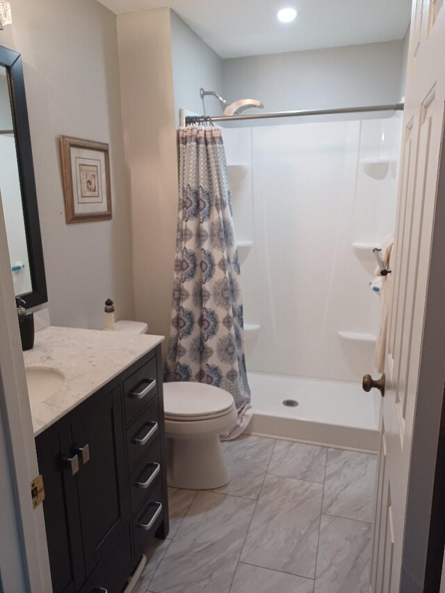 bathroom with vanity, toilet, and curtained shower