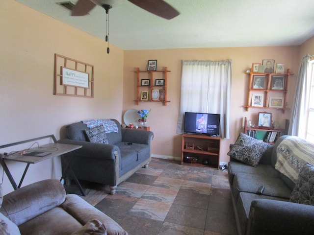 living room featuring ceiling fan and a healthy amount of sunlight