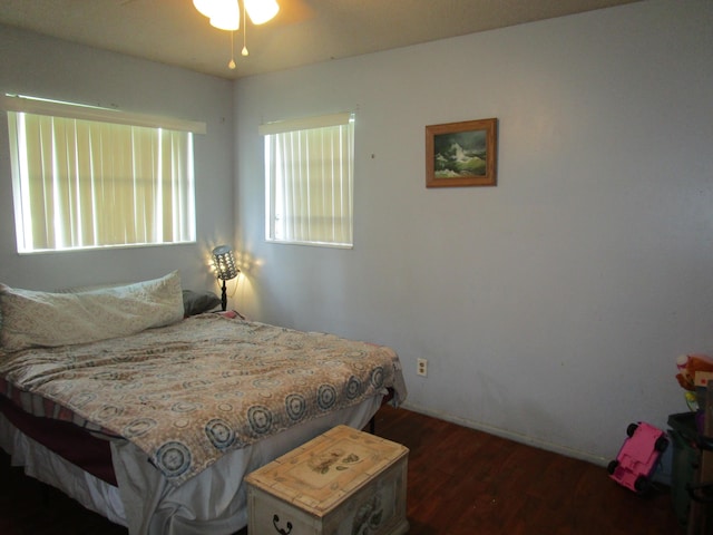 bedroom with dark hardwood / wood-style flooring