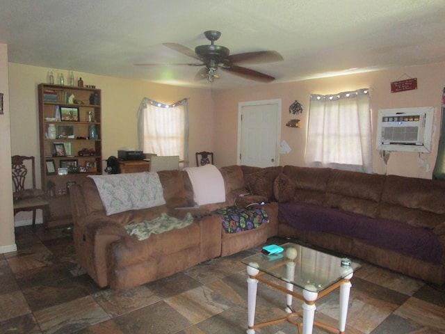 living room with an AC wall unit and ceiling fan