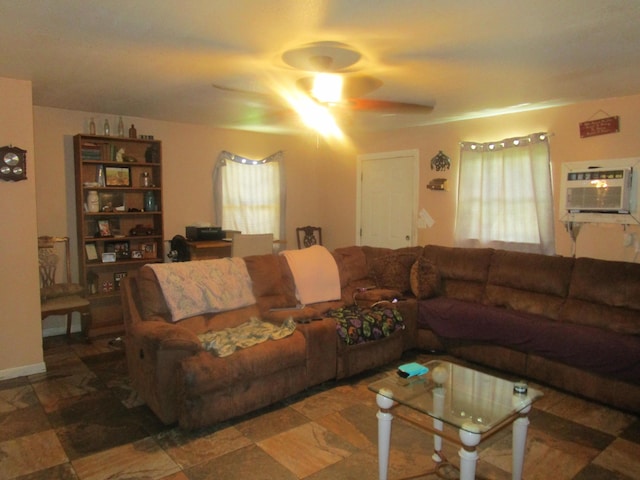 living room with a wall unit AC and ceiling fan