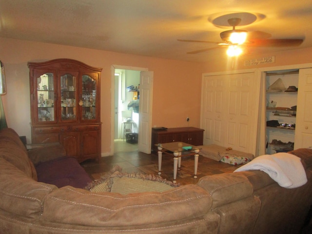 tiled living room featuring ceiling fan