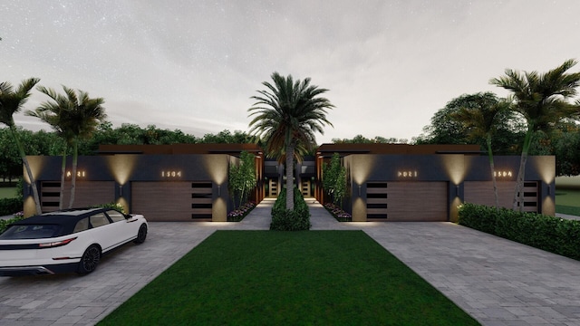 contemporary house featuring a front lawn and a garage