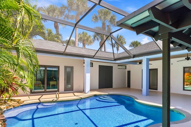 view of swimming pool featuring a patio area, ceiling fan, and glass enclosure