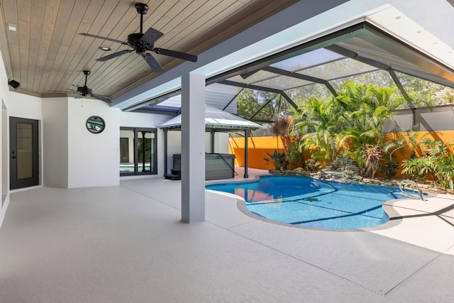 view of swimming pool featuring a patio, a lanai, and ceiling fan