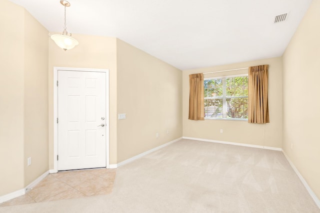 unfurnished room featuring light tile floors