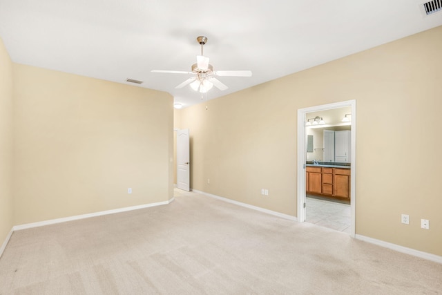 spare room with light carpet and ceiling fan