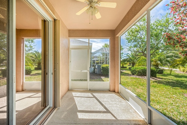 unfurnished sunroom featuring ceiling fan