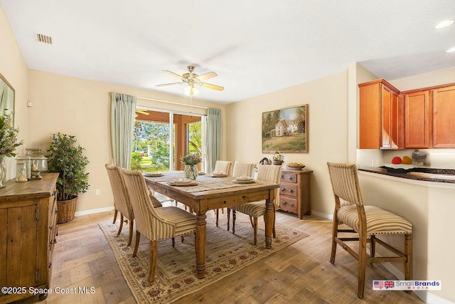 dining area featuring ceiling fan and light wood-type flooring