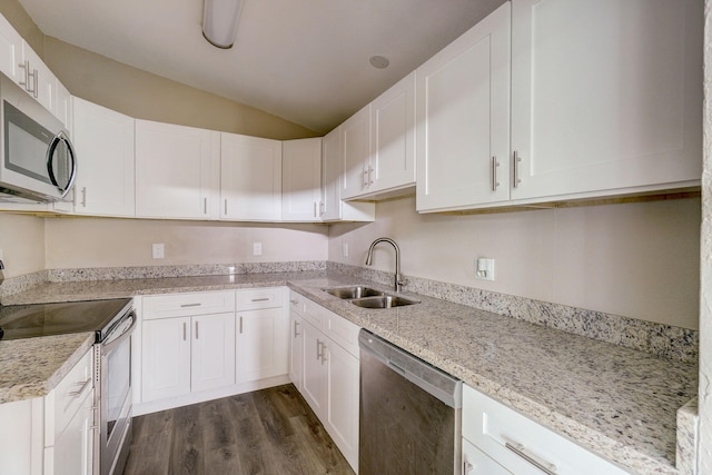 kitchen featuring stainless steel appliances, light stone countertops, white cabinetry, dark hardwood / wood-style floors, and sink